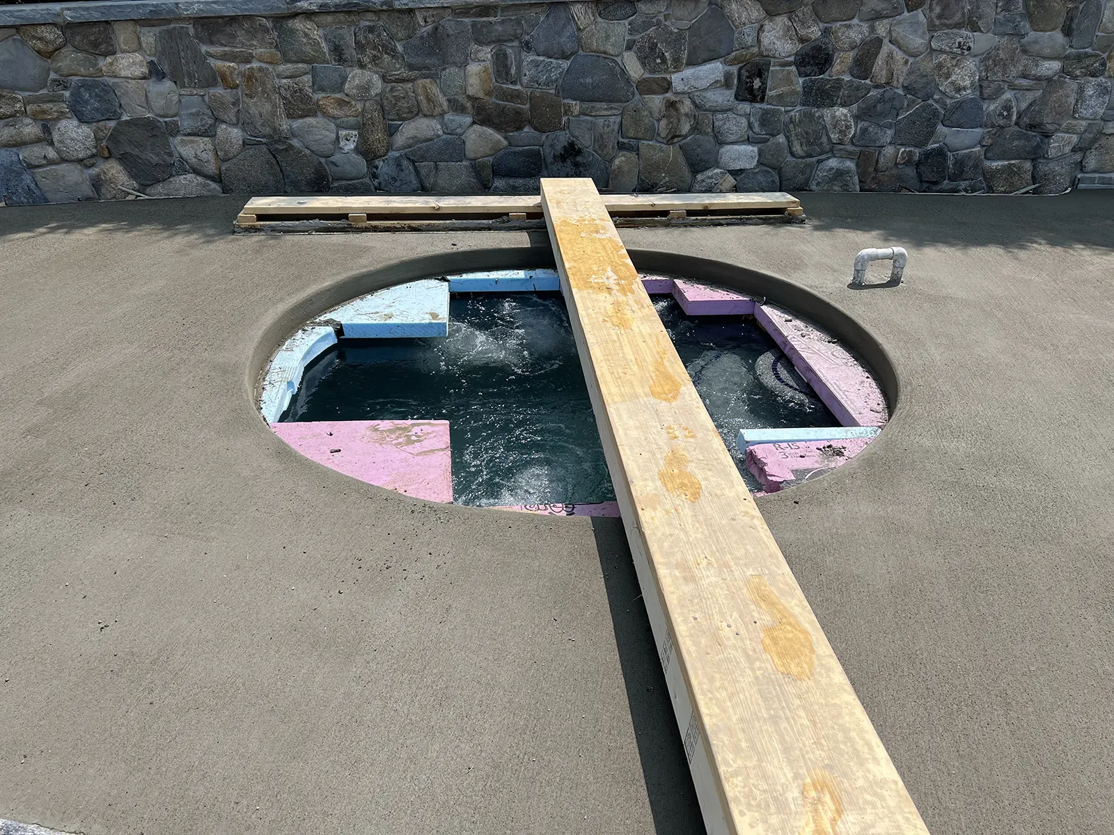 J-PAC Construction custom forming for automatic cover and cantilever coping on a circular hot tub and pool deck in Maine