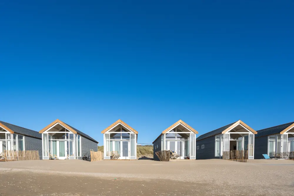 Prefabricated modern modular chalets and beachside cabins constructed on level groundPrefabricated modern modular chalets and beachside cabins constructed on level ground