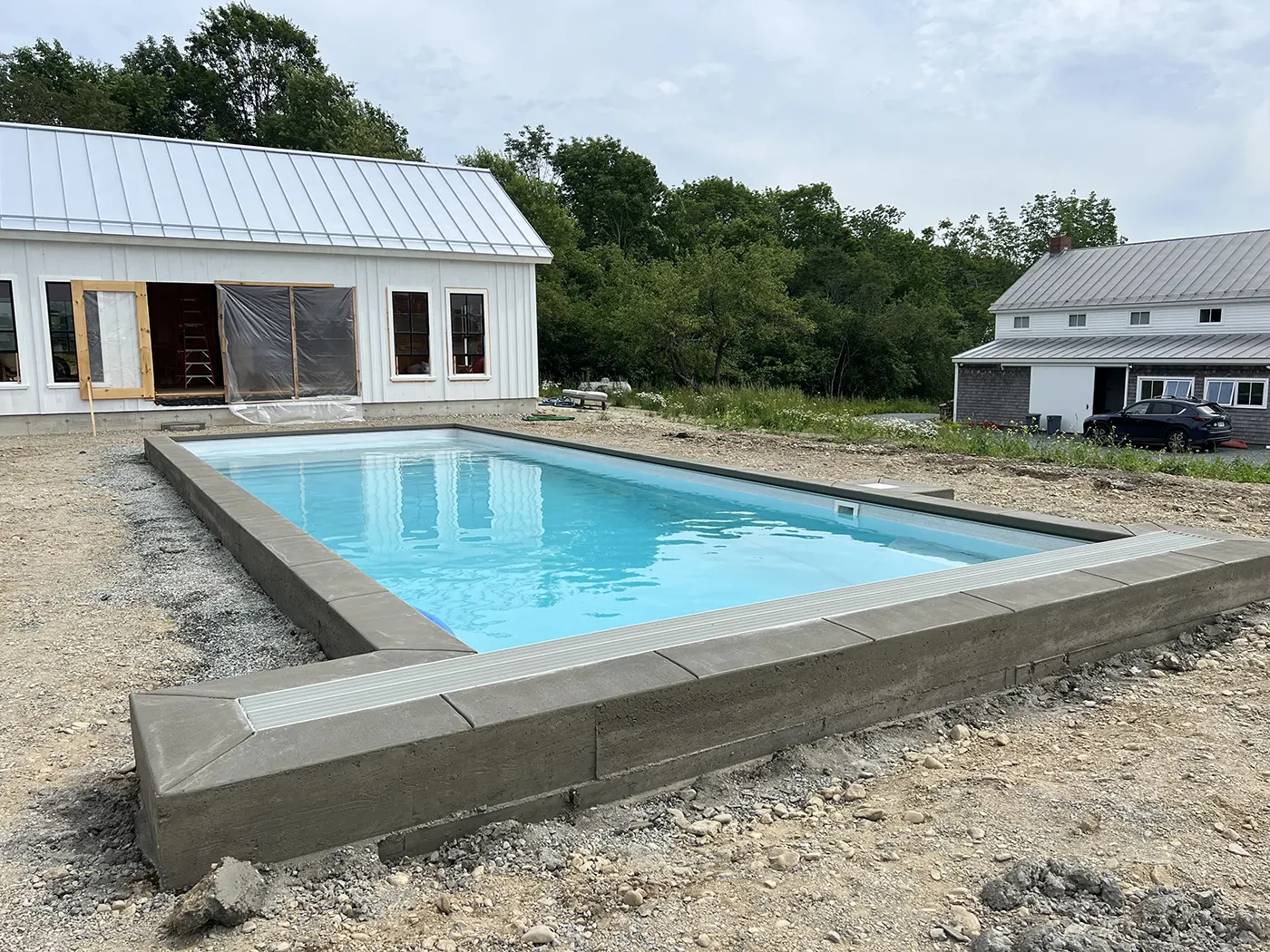J-PAC Construction smooth finish concrete pool border and coping installation for an outdoor inground pool in Maine